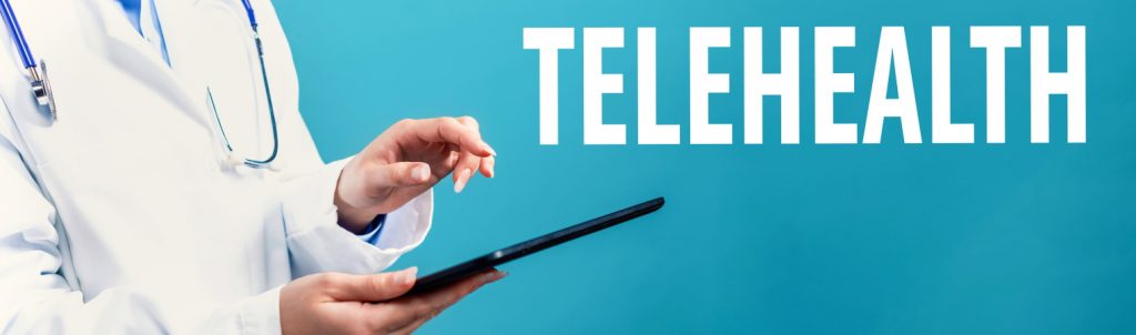 Doctor using a tablet for virtual consultation with the word telehealth on a blue background